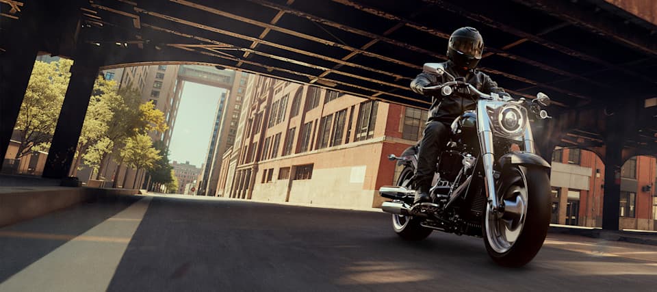 A cruiser motorcycle on a sunlit city street